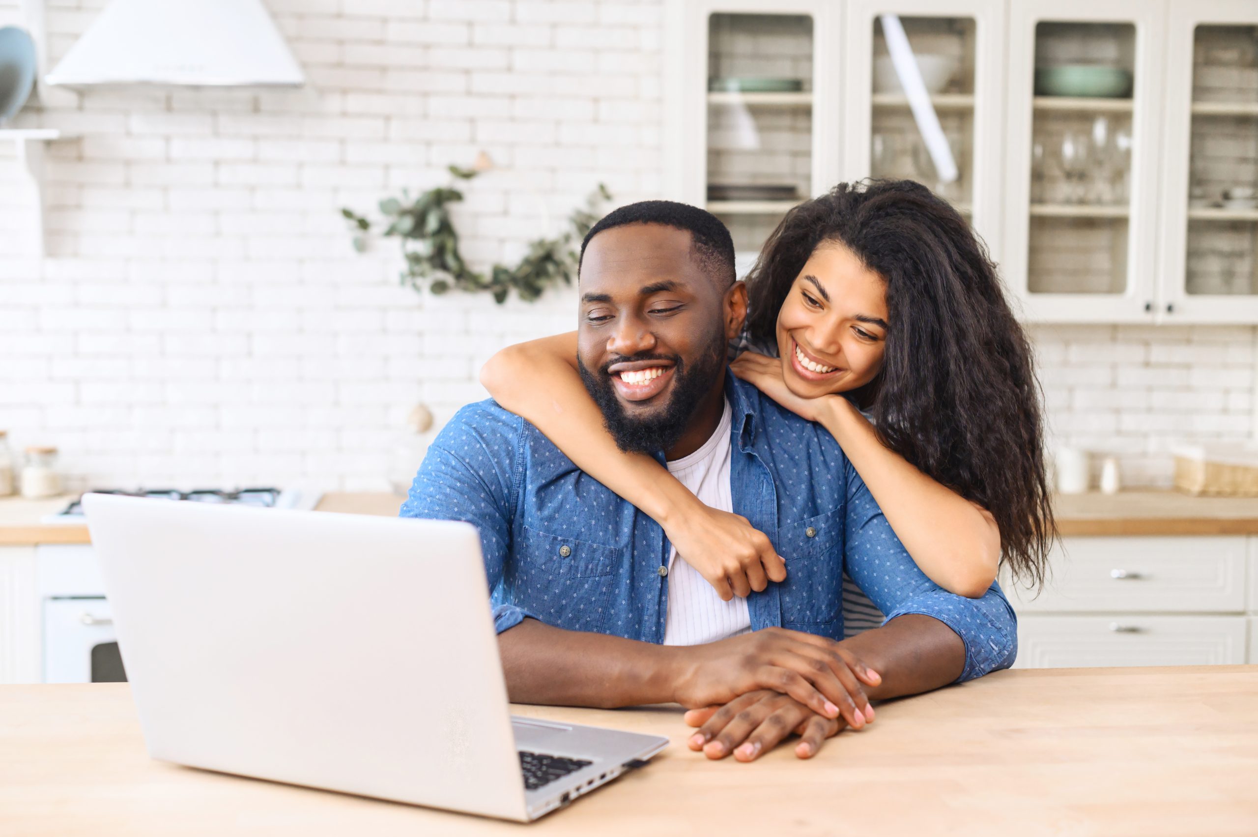 African-American couple with a laptp at home